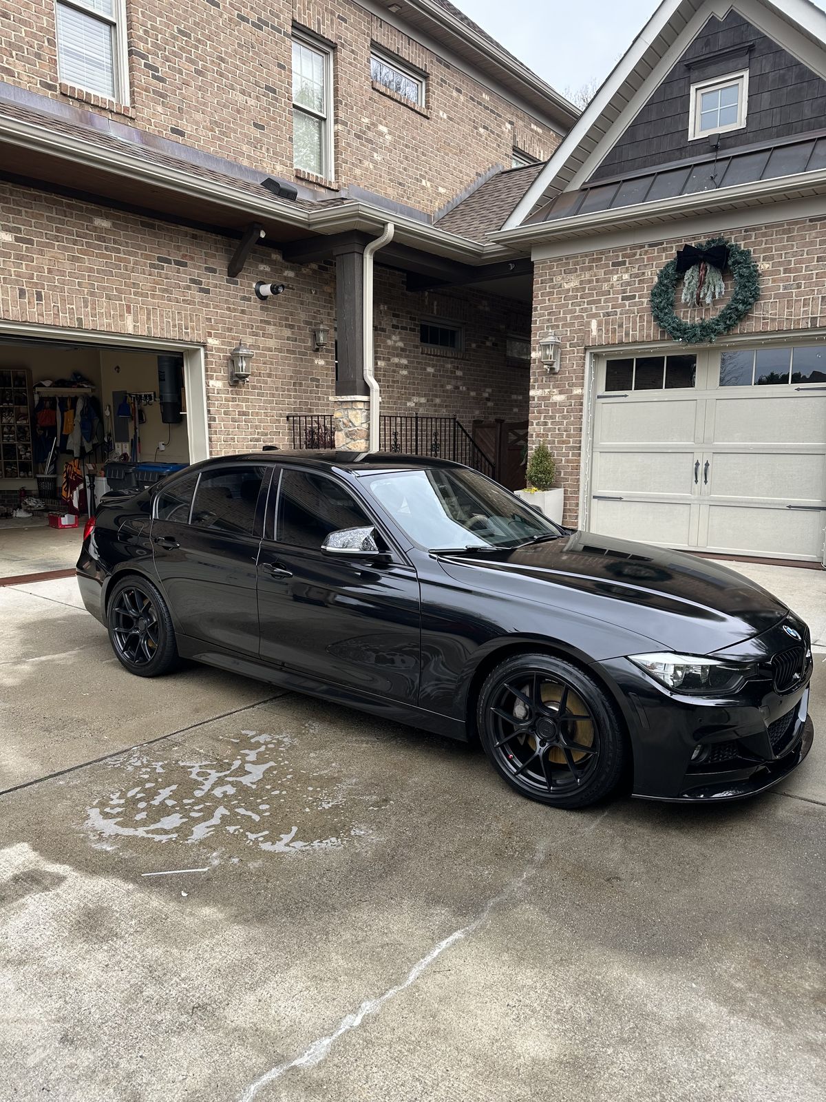 Black BMW 340i M Sport in driveway, front view