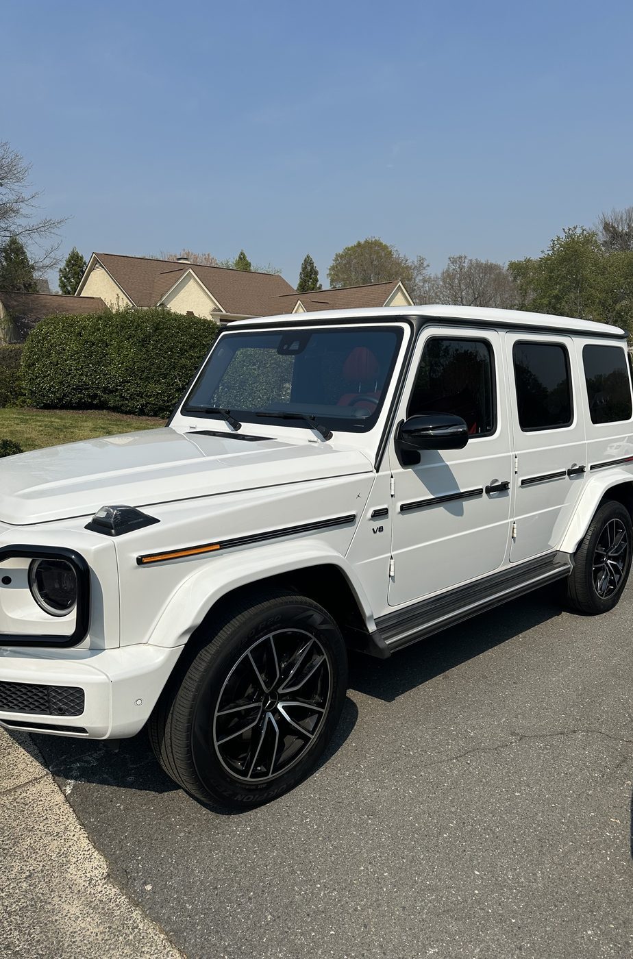 Hand-applied ceramic coating panel pass on a dark vehicle