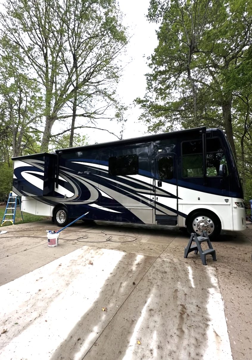 Class A motorhome at a wooded campsite, ready for detail